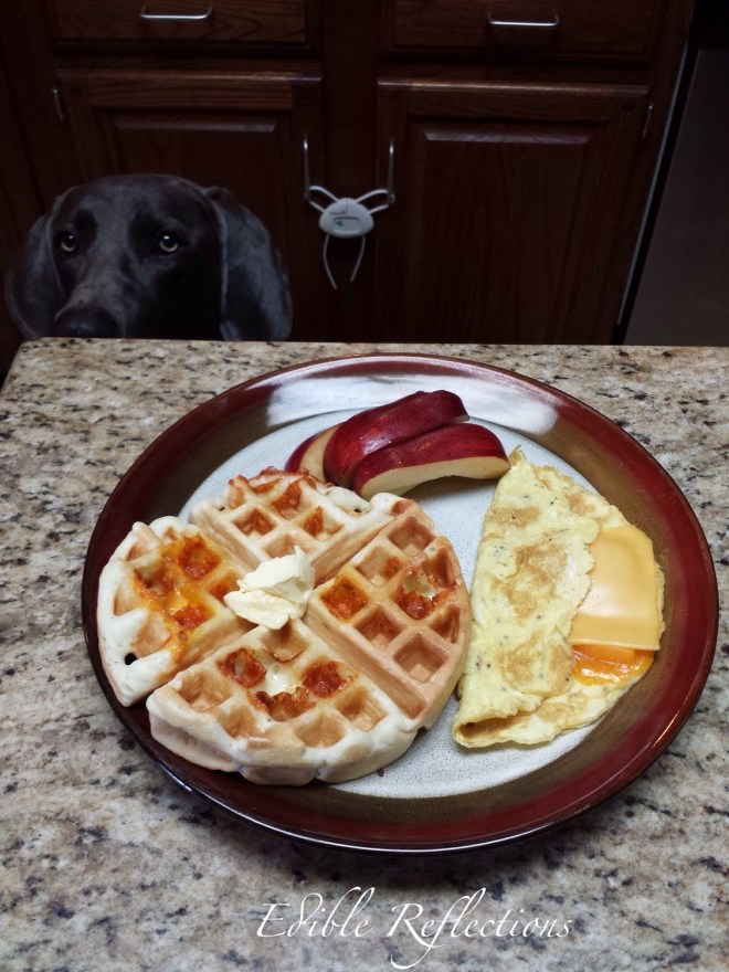 Homemade waffle, scrambled eggs and apple slices